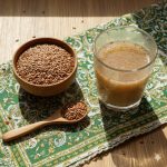 Flax Seeds in Pakistan — organic flax seeds in bowl and spoon with flaxseed drink